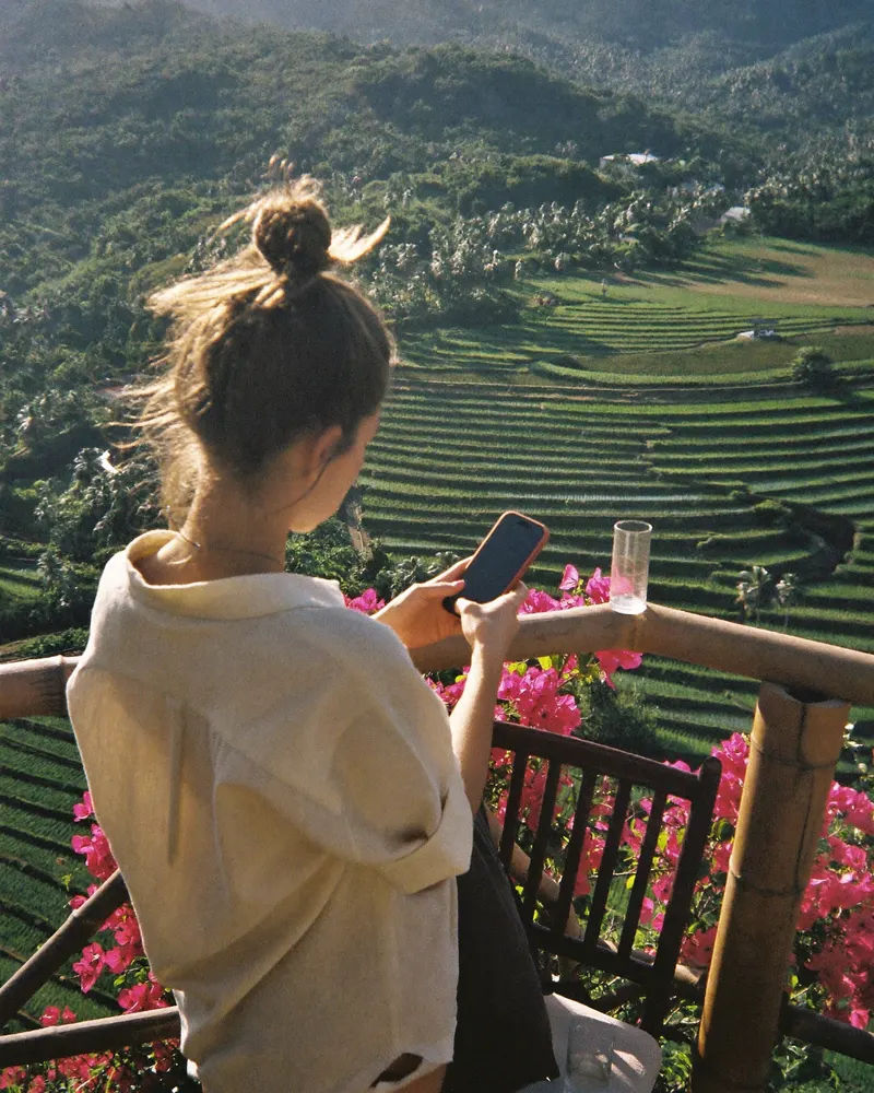 AI-generated image: a woman on Bali between rice terraces and bougainvillea