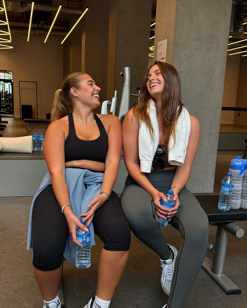AI-generated image: two friends laughing with water bottles after a workout